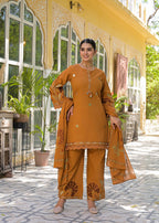 Close-up of intricate floral embroidery and lace cuff on mustard kurta sleeve