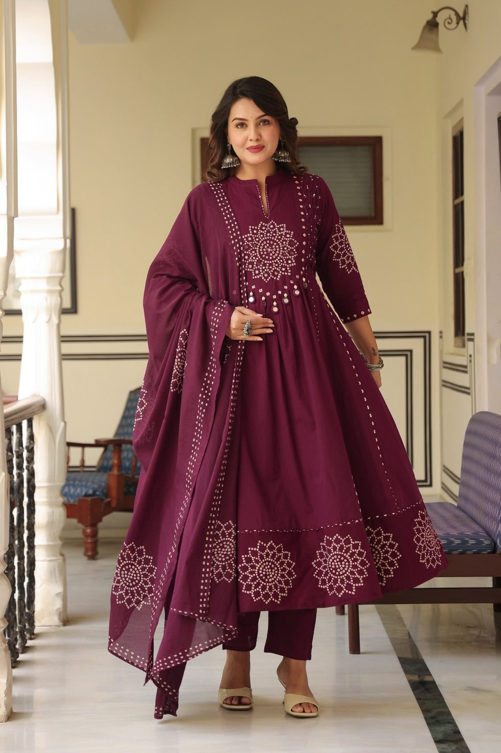 Wine Anarkali bandhani suit – balcony standing pose with dupatta display