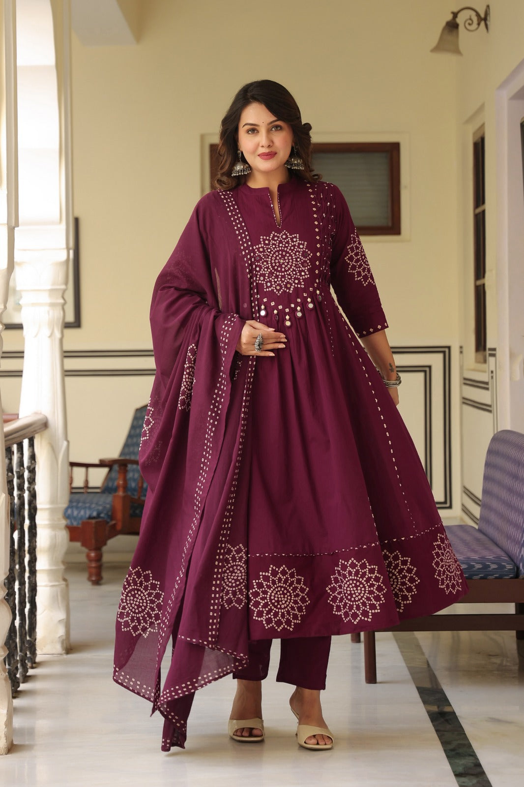 Wine Anarkali bandhani suit – balcony standing pose with dupatta display