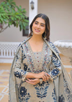 Beige brown ikat print suit – dupatta drape standing pose by fountain