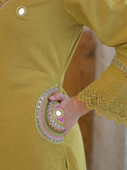 Olive yellow pure fabric suit – back view showing scalloped lace cuffs and hem border