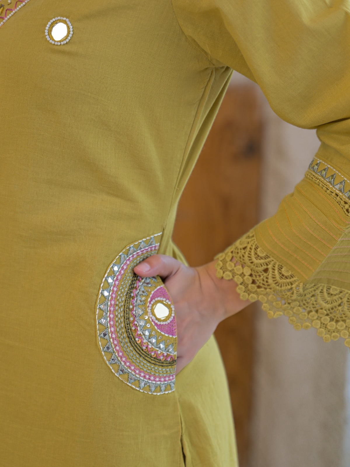 Olive yellow pure fabric suit – back view showing scalloped lace cuffs and hem border