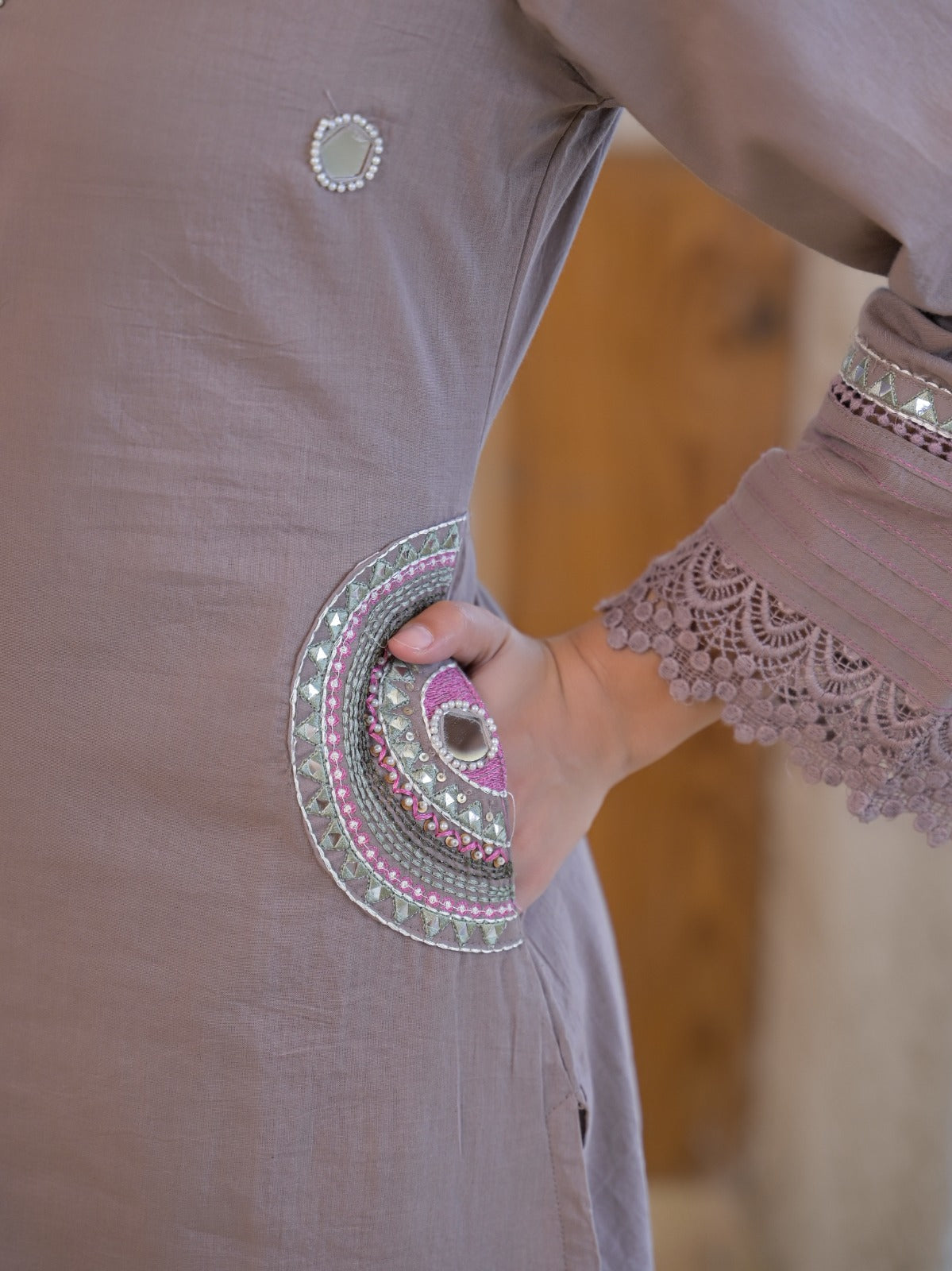 Mauve pink pure fabric suit – close-up neckline mirror embroidery and silk tassel detail